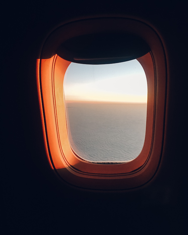 Airplane window at sunrise